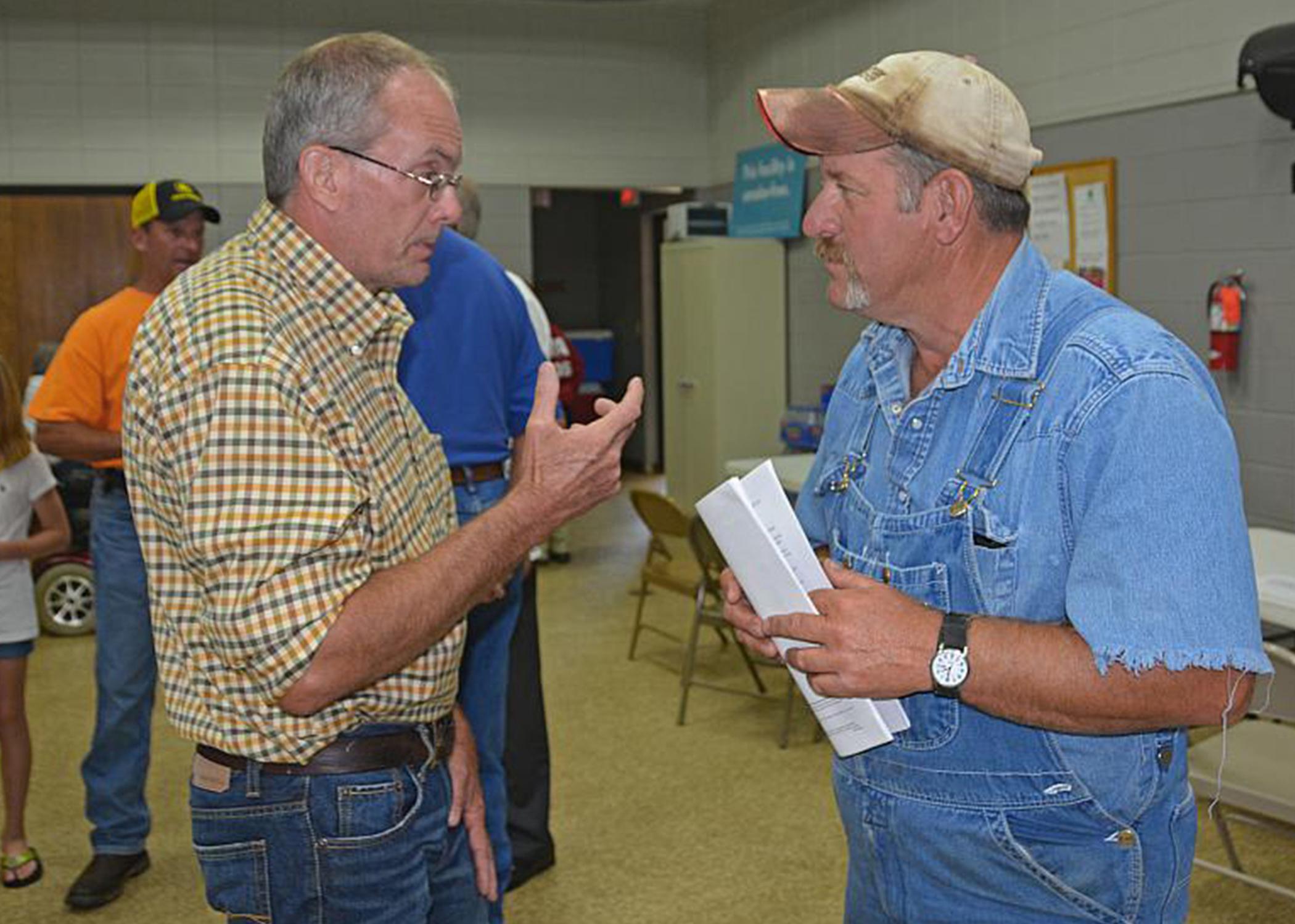 Winston County Extension agent Mike Skipper, left, discusses recovery issues from the April 2014 tornado with Rusty Suttle of Louisville at an Agricultural Disaster Resource Center set up May 15, 2014. (File photo by MSU Ag Communications/Linda Breazeale)