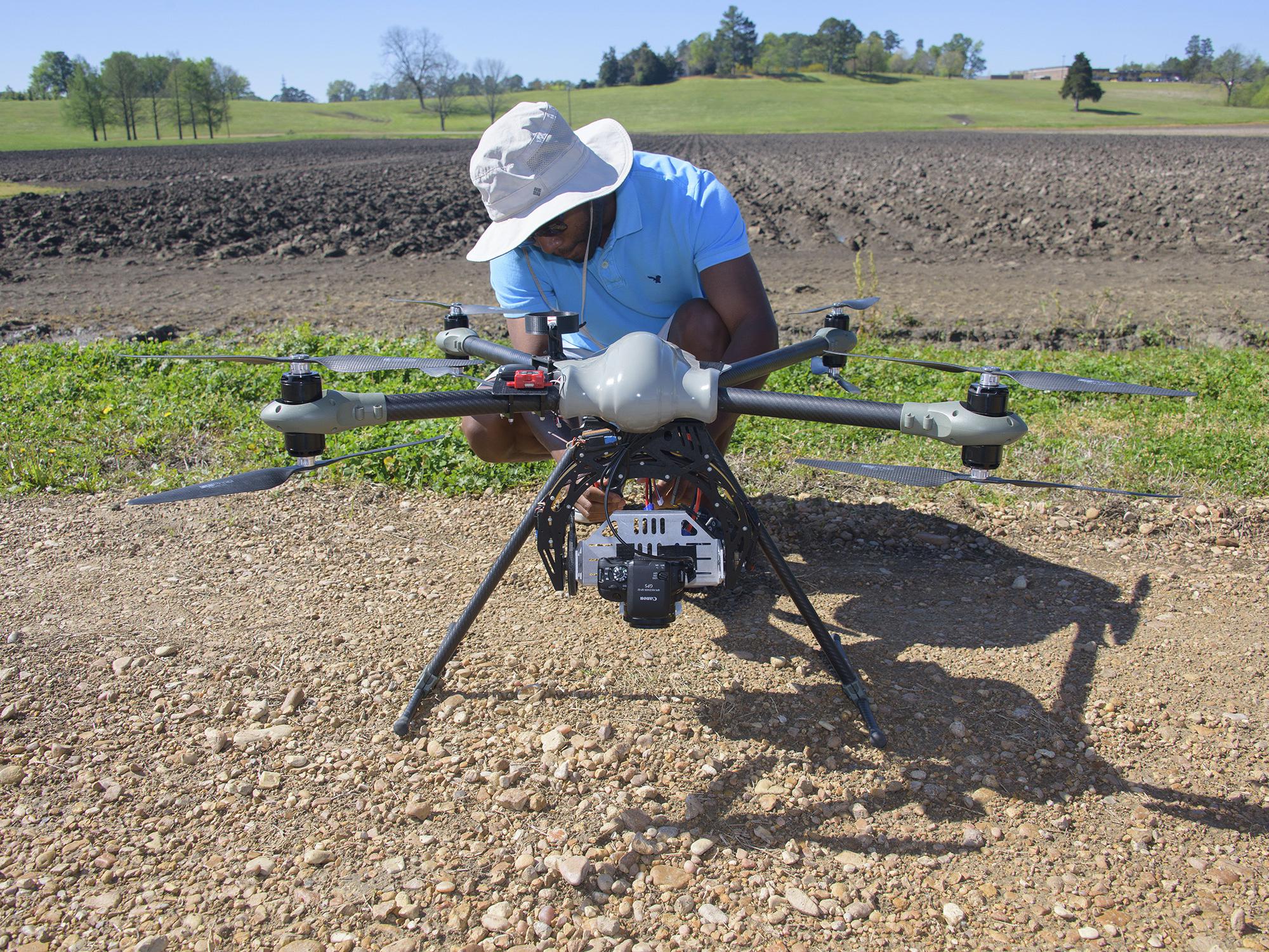 David Young, a flight coordinator with the Geosystems Research Institute at Mississippi State University, prepares an unmanned aircraft to fly over test plots at the H. H. Leveck Animal Research Center April 7, 2016. (Photo by MSU Extension/Kevin Hudson)