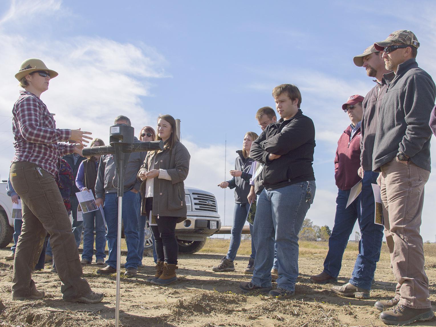 Rachel Stout Evans, a soil scientist with the Natural Resources Conservation Service, speaks to Mississippi State University Extension agents at a row crop farm in Shaw, Mississippi.