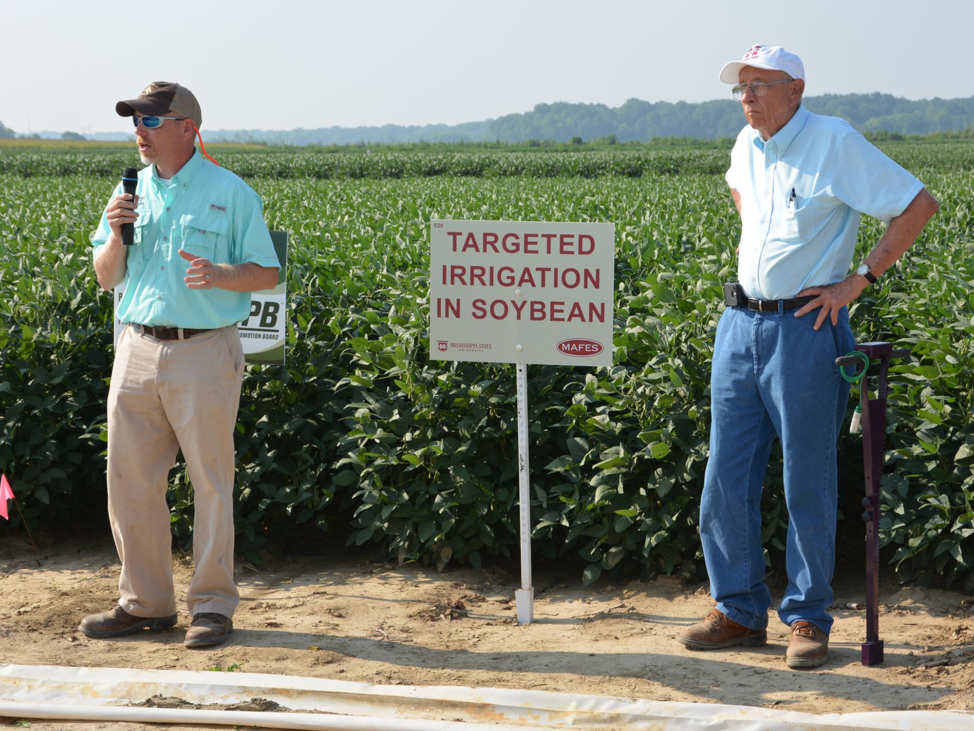 Jason Krutz (left), irrigation specialist for the Mississippi State University Extension Service, and Normie Buehring, research professor at the Northeast Mississippi Experiment Station, discuss soybean irrigation at the 2014 North Mississippi Research and Extension Center Agronomic Row Crops Field Day. The biennial event will be Aug. 11, 2016 in Lee County. (File Photo/ MSU Extension Service) 