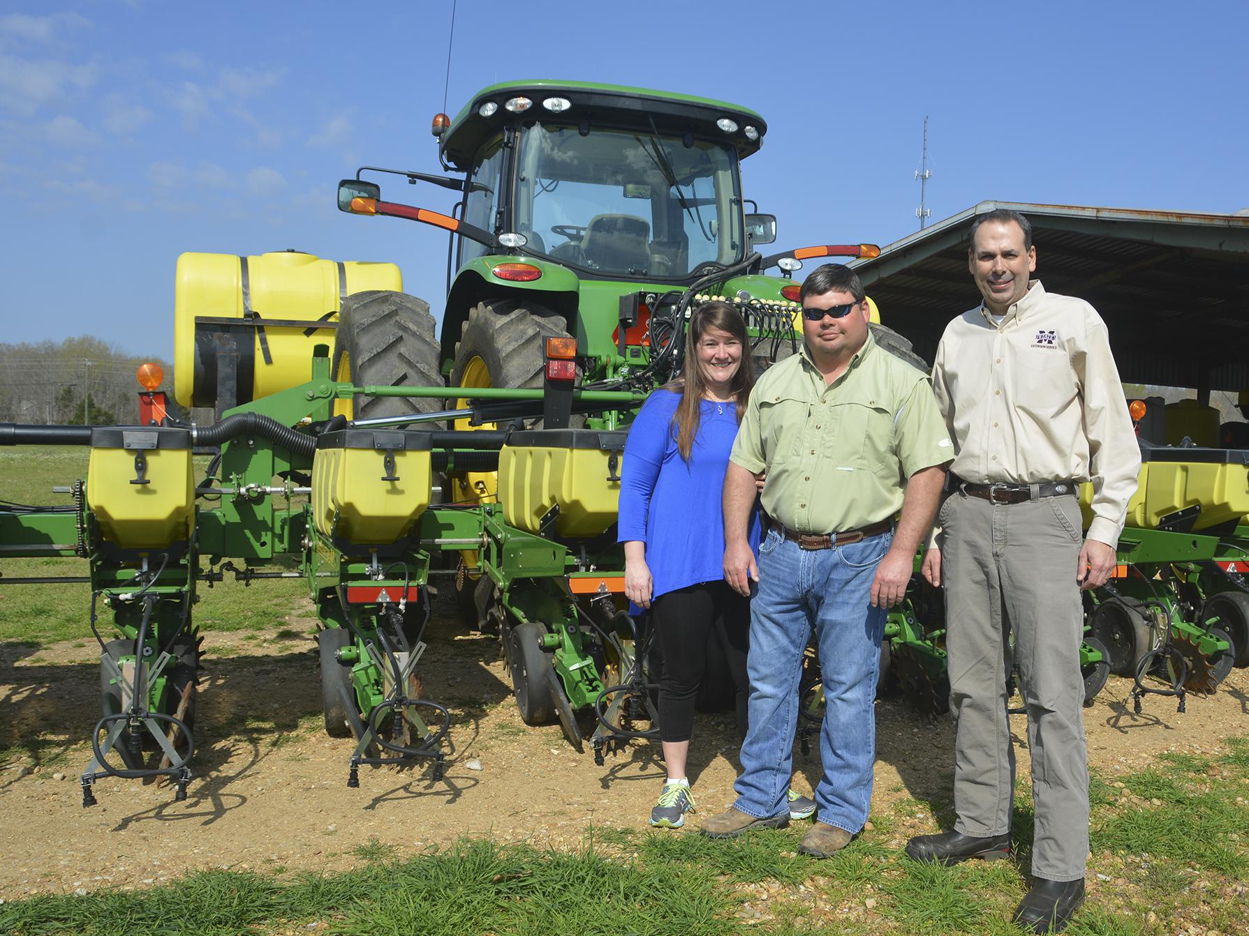 Molly and Brad Judson of Clay County are one of four couples who recently earned the National Outstanding Young Farmers award. They were nominated by Charlie Stokes, right, their Mississippi State University Extension Service agent, for the recognition from the National Association of County Agricultural Agents. (Photo by MSU Extension Service/Linda Breazeale)