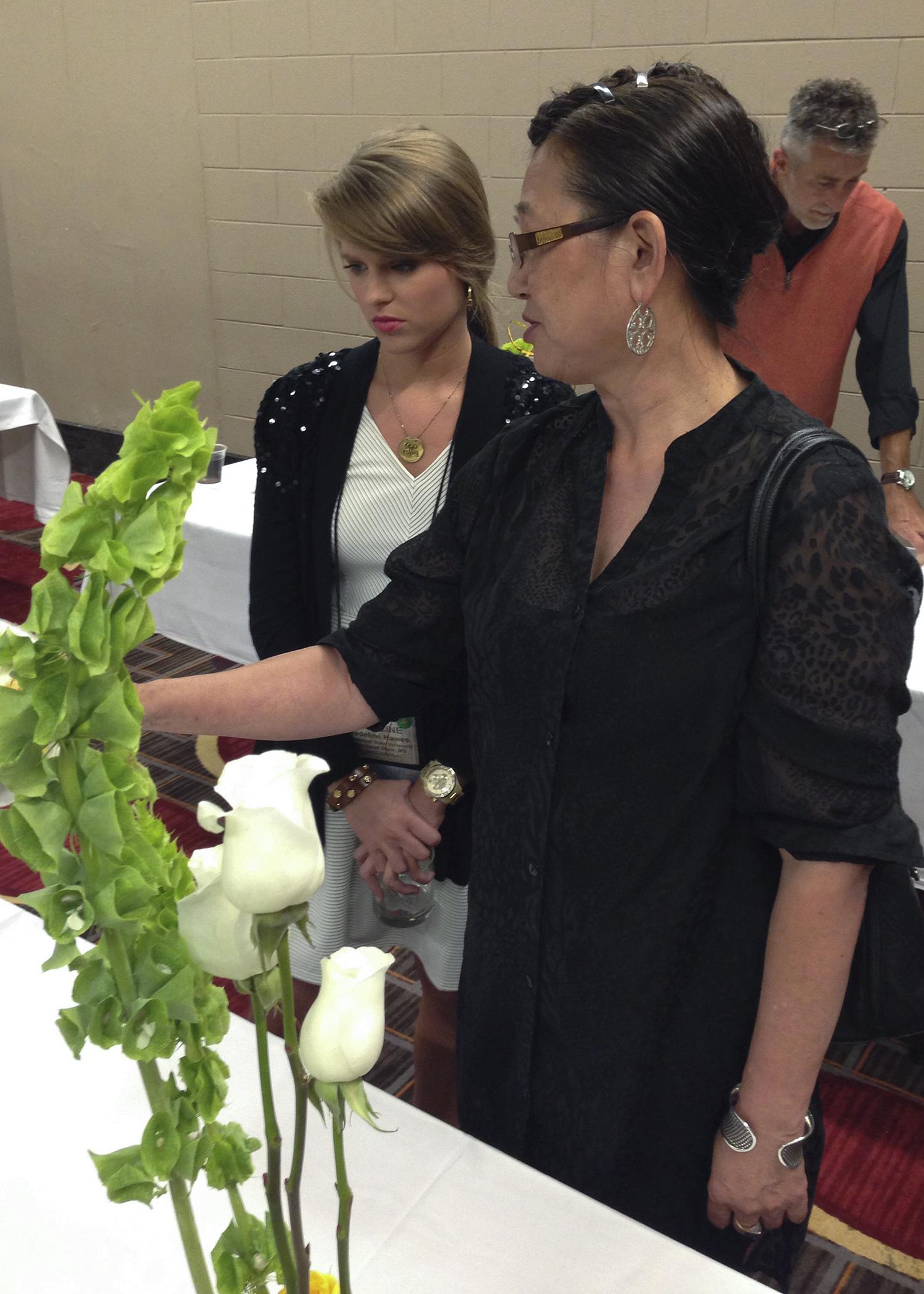Mississippi State University student Madeline Hawes of Sikeston, Missouri, receives a design critique at July's American Institute of Floral Designers symposium in Chicago from Hitomi Gilliam, an internationally renowned floral artist. (Photo by MSU Plant and Soil Sciences/Jim DelPrince)