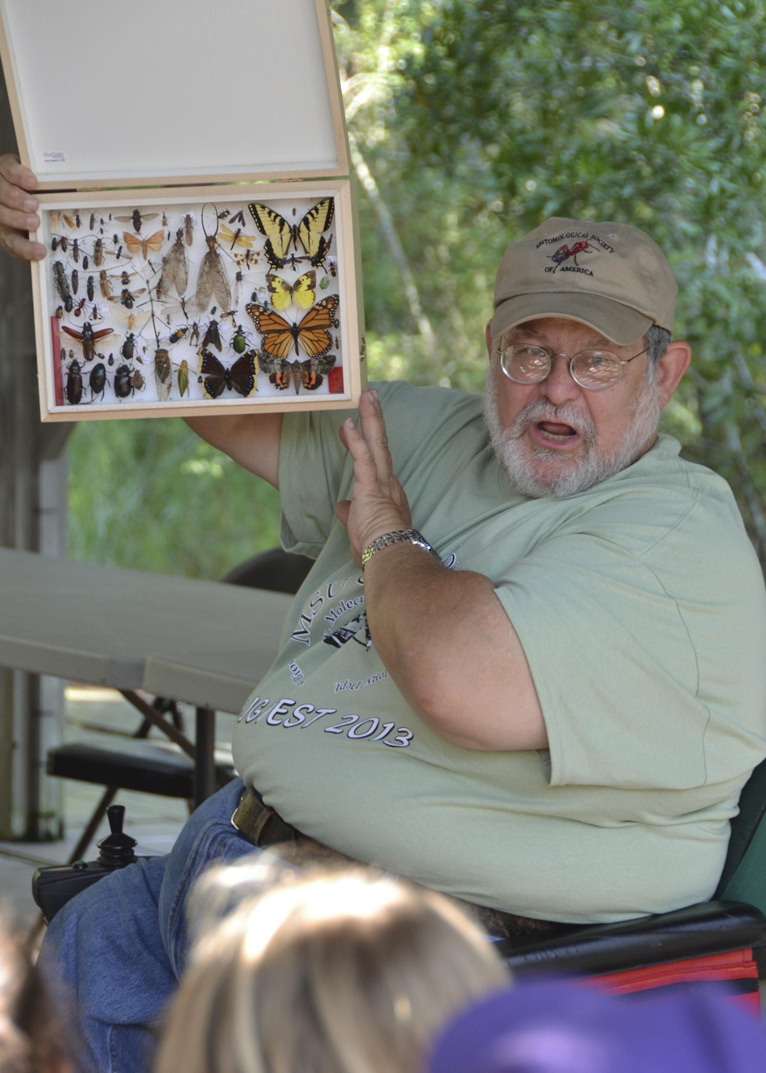 John Guyton, Mississippi State University Extension entomology specialist, shares an insect collection with a school group on Sept. 27, 2013, during Bugfest at the Crosby Arboretum in Picayune. Participants in this year's two-day event can take part in insect collection and identification, tours of the pitcher plant bog, tree identification hikes, a beekeeping tutorial and more. (Photo by MSU Ag Communications/Susan Collins-Smith)