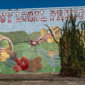 A mural that lists Buy Local Produce.