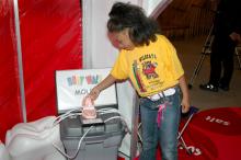 Kelcei Williams, a first grader at Wilkins Elementary School in Jackson, looks at a mouth full of teeth at one of the nine interactive learning stations in the Body Walk exhibit.