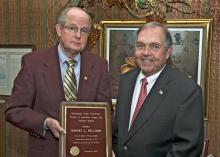 MSU Vice President for Agriculture, Forestry and Veterinary Medicine Vance Watson, right, presents a plaque to Robert L. Williams recognizing the scholarship honoring the agricultural economist. (Photo by Bob Ratliff, MSU Office of Ag Communications)