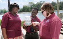 Amy Schmidt, right, Extension water quality specialist, shows 4-H youth agents Navlean Pittman of Lawrence County and Patrick Morgan of Copiah County a groundwater model depicting a water table. The three attended in-service training for state 4-H agents held recently in Tupelo. (Photo by Jim Lytle)