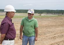 MAFES agronomist David Lang, left, talks with North American Coal environmental specialist Judd Sanborn about preparations for planting switchgrass on reclaimed mine land. (Photo by Marco Nicovich)