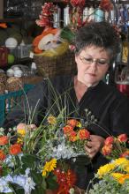 The University Florist staff stays busy preparing arrangements for weddings, parties and other special occasions. Lynette McDougald is preparing these floral arrangements for an event at the Union.