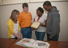 Looking over their winning application for national recognition are Mississippi State University Collegiate 4-H'ers, from left, Savannah Duckworth of New Albany, Stuart Wright of Columbus, Brittany Reed of Greenwood and Shad Benn of Hattiesburg. (Photo by Scott Corey)  