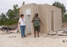 Mae Gladys Dotson, right, shows Choctaw County Extension director Juli Hughes where she sought shelter when the April 24 tornado destroyed her home. (Photo by Scott Corey)