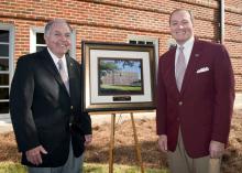 The newly renovated and renamed Lloyd-Ricks-Watson building at Mississippi State University was dedicated on Oct. 23. Vance Watson, left, one of the buildings' namesakes, receives a photo of the building from MSU president Mark Keenum. (Photo by MSU University Relations/Russ Houston)