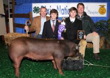 John Lundy (back left) and Eric Clark (back right) along with First South Farm Credit, Wilson's Meat House, Cecil Harper, Kipp Brown and Jim Newsome purchased a Champion Durac Hog from Tanner Ainsworth (front left) and Cory Ainsworth (front right) at the 2011 Dixie National Sale of Junior Champions. The buyers donated the meat to the Leroy Shook family. (Photo by Scott Corey)