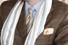 Mixing patterns is fashionable when a common element unites them, such as the color blue and its complimentary colors orange and tan, as seen in the details of this combination of a tailored plaid jacket, checked shirt, polka-dot pocket scarf and tie, and striped scarf. (Photos by Kat Lawrence)