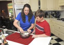 Debbie Huff and her youngest son, John Mark, prepare goat cheese in their kitchen. The Huffs' four sons show dairy goats in 4-H and also make and sell goats' milk products.