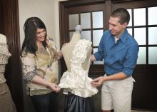 Mississippi State University senior Justin Phelps of Madison shows alumna Robin Cox the draping project he completed in the apparel, textiles and merchandising program. Cox returned to her alma mater to share her career experiences as a corporate merchandise planner for national retailer jcpenney during the Senior Showcase. (Photo by MSU Ag Communications/Scott Corey)