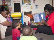 From left, Brenda Wright, owner of Heavenly Hearts Learning Center in Nesbit, joins Schmaya Miller, Kingston Jenkins and Ken'Narius Johnson to listen as LaLetrice Fletcher, field technical assistant with the Nurturing Homes Initiative, reads them a book. (Photo by MSU Extension Service/Alicia Barnes)