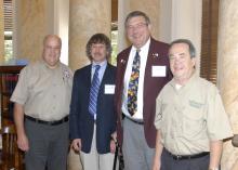 Rep. Scott Bounds, from left, Jerry Belant and Bruce Leopold of the Mississippi State University Center for Human-Wildlife Conflicts, and Sen. Giles Ward took part in the Mississippi Legislative Wild Hog Summit on Sept. 9, 2013, in Jackson, Miss. (Photo by MSU Ag Communications/Linda Breazeale)
