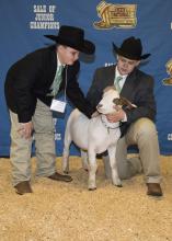 Jacob Owen, left, and his older brother, Tyler, prepare to enter the arena for the Dixie National Sale of Junior Champions with their market goat, Splits, on Feb. 12, 2015, in Jackson, Mississippi. (Photo by MSU Ag Communications/Kevin Hudson)