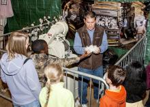 Dennis Reginelli, an area agronomic crops agent with the Mississippi State University Extension Service, explains the ginning process that helps create cotton fabrics. Addressing primarily third-graders at the Mississippi Horse Park on Nov. 7, 2013, Reginelli and the cotton exhibit were part of Farmtastic, a four-day educational program designed to help children learn the sources of their food, clothing and other products. (Photo by MSU Ag Communications/Scott Corey)