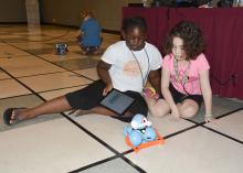 Samyra Harris, left, and Julia Schloemer focus intently on their Dash robot during the 4-H Cloverbud Robotic Camp at Mississippi State University on July 7, 2015. (Photo by MSU Ag Communications/Linda Breazeale)
