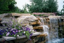 Blue Wave petunia, Aztec Silver Magic verbena and AngelMist Purple Stripe angelonia make for a great combination planting to complement this spectacular water feature.