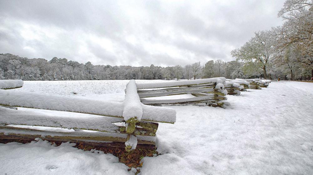 Snow covers a split-rail fence and trees near Mount Locust on the Natchez Trace in Jefferson County, Mississippi on Dec. 8, 2017.