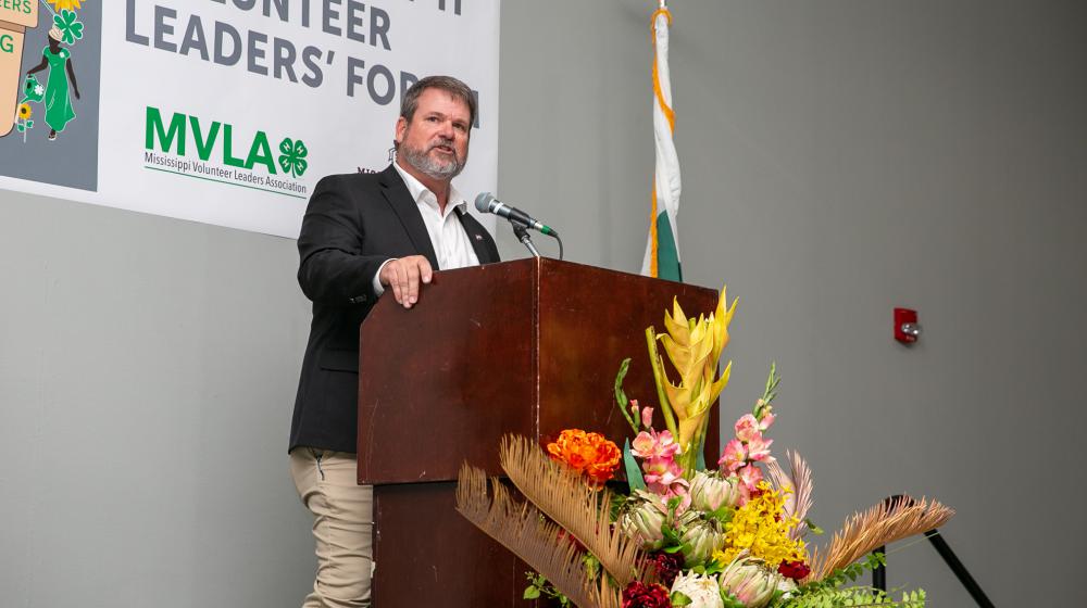 A man standing at a podium with a microphone.