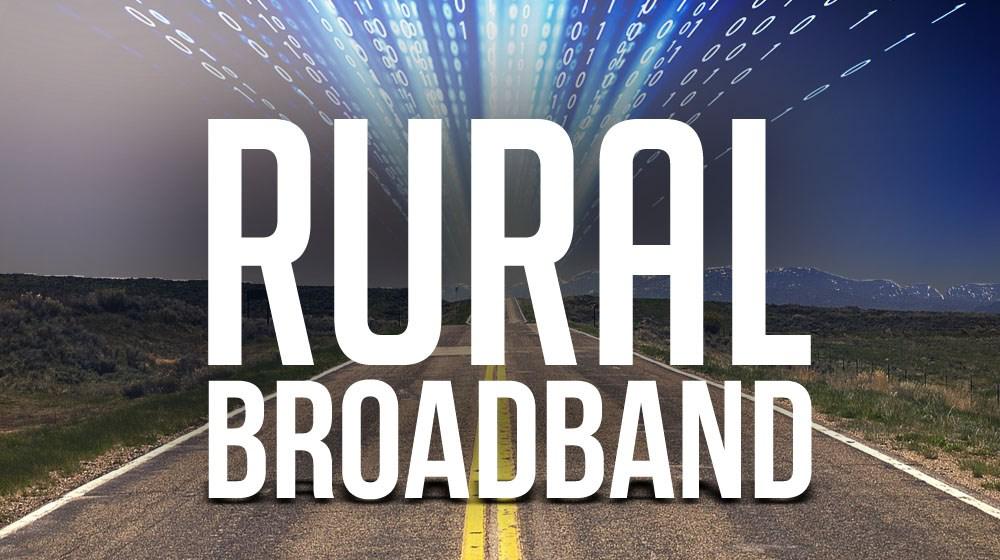 Photo illustration with two-lane highway with computer code and the words "Rural Broadband" superimposed.