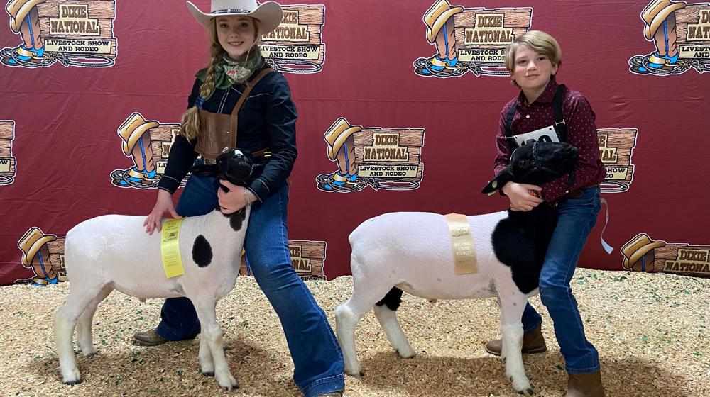 Two 4-H'ers with their show animals.