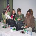 4-H Military Project coordinator Whitney Mathis, from left, provides military wives Marianne Breland and Melissa Tanksley with Hero Packs containing special items to show support of children with parents deployed in Operation Iraqi Freedom. Sheran Watkins, 4-H youth agent in Harrison County, also looks at the materials designed to lift the spirits of children missing their loved ones.