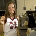 Lauren Beatty is equally at home on the football as a Mississippi State University cheerleader and in the science laboratory. (Photo by Marco Nicovich)