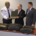 Dr. Vance Watson, MSU Extension Director, presents a used computer to Bolton Police Chief Michael Williams. Watson presented the equipment with Jay Ledbetter, director of the Mississippi Department of Homeland Security. (Photo by Ned Browning)