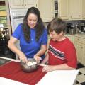 Debbie Huff and her youngest son, John Mark, prepare goat cheese in their kitchen. The Huffs' four sons show dairy goats in 4-H and also make and sell goats' milk products.