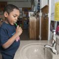 Mississippi State University Aiken Village Preschool student Deshaun Phillips brushes his teeth to prevent cavities and maintain good dental hygiene on Feb. 18, 2013. (Photo by MSU Ag Communications/Scott Corey)