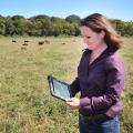 Mississippi State University professor of animal and dairy sciences and Extension beef cattle specialist Jane Parish uses an application on an iPad to review cattle break-even prices while in the field at the Henry H. Leveck Research Farm on the south side of the MSU campus in December 2013. (File Photo by MSU Ag Communications/Scott Corey)