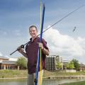 Mississippi State University senior Charles Parker recently won $10,000 during MSU's Office of Entrepreneurship and Technology Transfer Entrepreneurship Week for his fishing pole protectors, called Rod Sox. Parker is shown here at MSU's Chadwick Lake on May 13, 2014. (Photo by MSU Office of Public Affairs/Megan Bean)