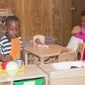 The children of Destiny's Day Care in Louisville, Mississippi, enjoy new classroom equipment in their temporary location on May 16, 2014, after the original site was destroyed by a tornado. With assistance from many, including MSU early care and education programs, the center reopened seven days after the storm. (Photo by MSU School of Human Sciences/Alicia Barnes)
