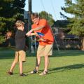 Eddie McReynolds of Starkville helps his 10-year-old son, Reece, develop his throwing skills for a game of disc golf. The McReynoldses practiced together near the Starkville Sportsplex on Sept. 3, 2014. (Photo by MSU Ag Communications/Linda Breazeale)
