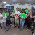 A diverse group of youth displaying 4-H signs.