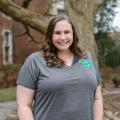 A standing woman smiling and wearing a Tennessee 4-H polo.