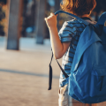 Boy with blue backpack.