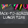 Colored pencils, paper clips, tacks, markers, a ruler, scissors, and a pencil rest at the top of a chalkboard with Back-to-School Lunch Tips written on it in white chalk.