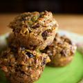 Five baked muffins loaded with fruit and nuts on a green floral plate. (Photo by MSU Extension Service/Kevin Hudson)