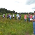 Brett Rushing, an assistant professor at Mississippi State University, discusses various planting and maintenance methods used on four native wildflower plots at the MSU Coastal Plains Branch Experiment Station in Newton on July 13, 2017, during the Wildflower Field Day. (Photo by MSU Extension Service/Susan Collins-Smith)