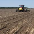Clear skies have been rare sights as Mississippi farmers started planting their 2016 crops. This soybean planter is establishing a variety trial in a Sunflower County field on May 10, 2016. (MSU Extension Service photo/Greg Flint)