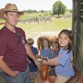 Mississippi State University animal and dairy science major Jacob McCarty of Summit, left, shows Starkville Academy student Abby Edwards how to sit properly in a saddle during Afternoon on the Farm May 1, 2015. The activities took place at the H.H. Leveck Animal Research Center at MSU, commonly called the South Farm, in Starkville. (Photo by MSU Extension Service/Kat Lawrence)