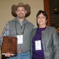 Rocky Lemus receives a merit award from Yoana Newman, a member of the American Forage and Grassland Council Board and Foundation Board, during the recent annual conference in Memphis on Jan. 14, 2014. (Photo by Virginia Tech/Chris Teutsch)