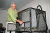 Frank Davis displays one of the large cages developed for holding adult southwestern corn borer moths at the U.S. Department of Agriculture's Agricultural Research Service facility in Starkville. (Photo by Linda Breazeale)