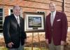 The newly renovated and renamed Lloyd-Ricks-Watson building at Mississippi State University was dedicated on Oct. 23. Vance Watson, left, one of the buildings' namesakes, receives a photo of the building from MSU president Mark Keenum. (Photo by MSU University Relations/Russ Houston)